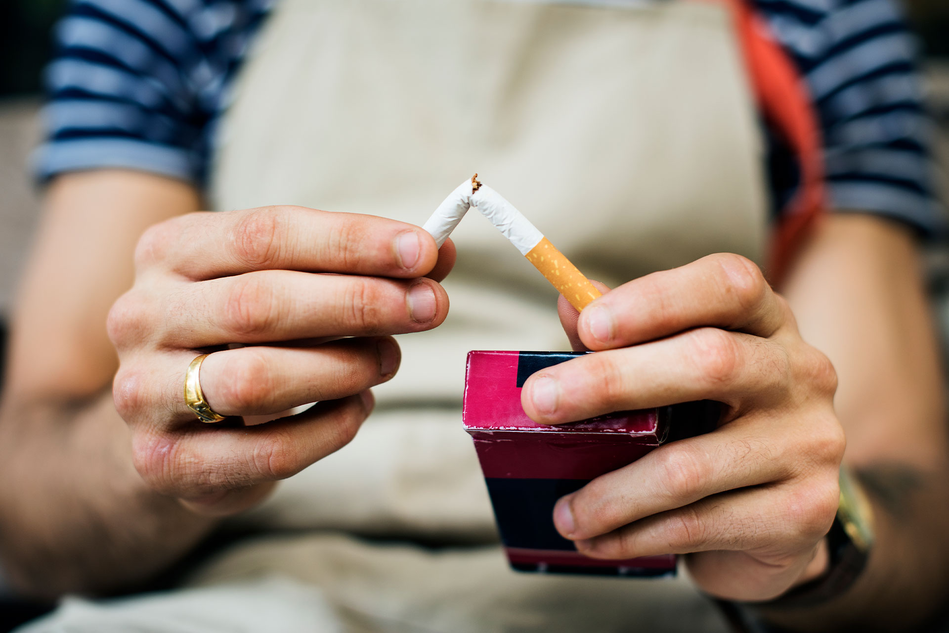 Woman's hands breaking a cigarette