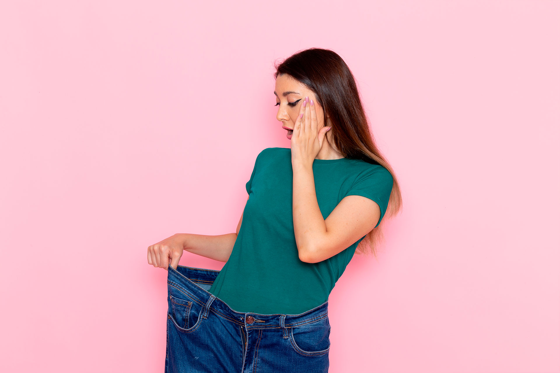 Thin woman looking at herself in the mirror