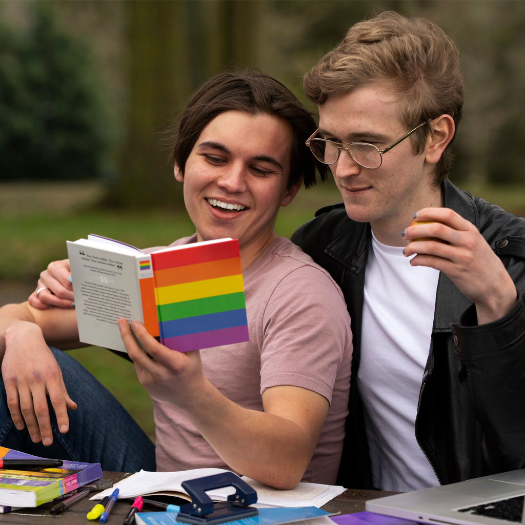Two gay students reading a book